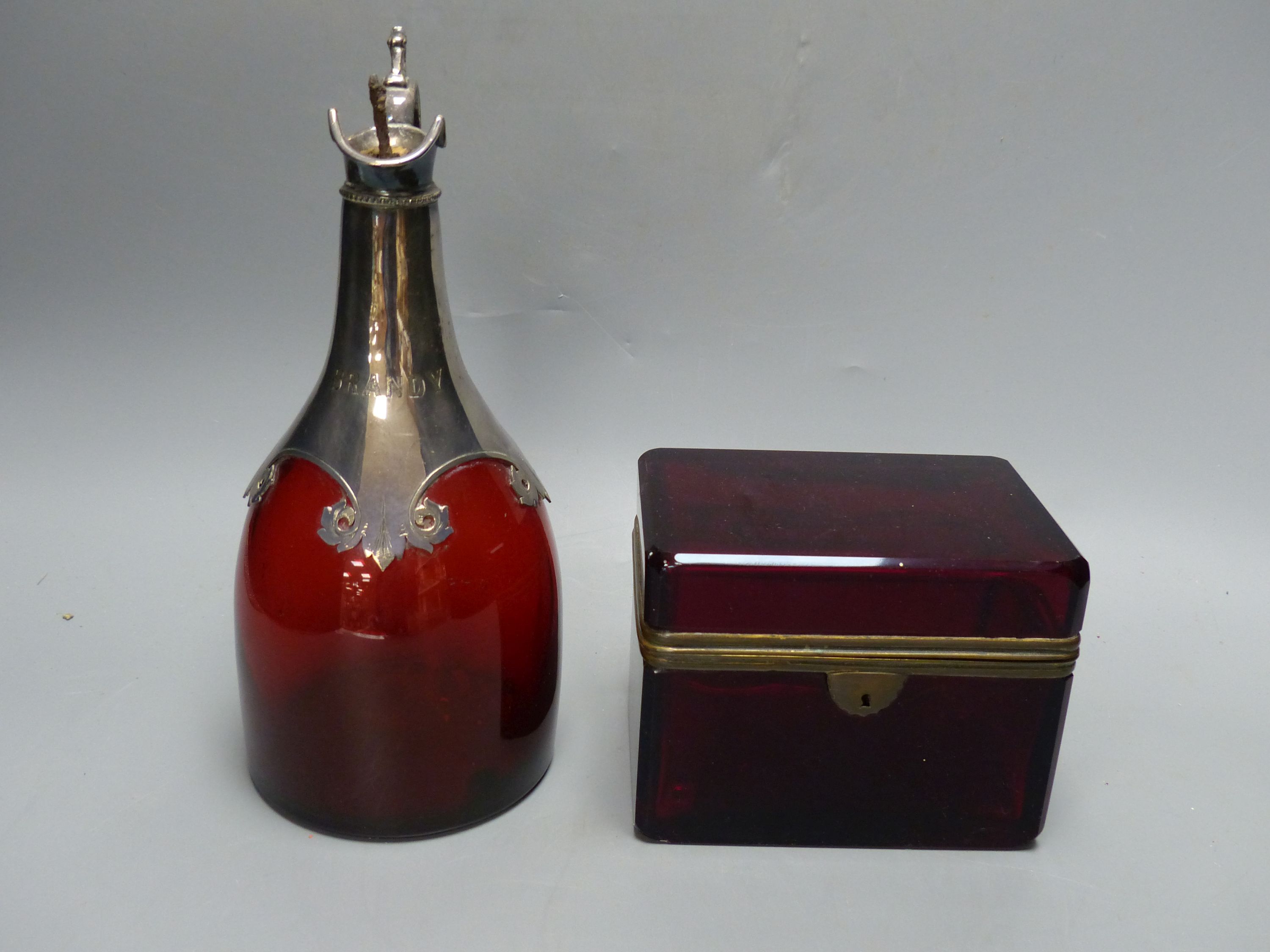 A late 19th century Bohemian ruby glass casket, a Victorian ruby glass and electroplate claret jug, a pair of glass candle holders, sim